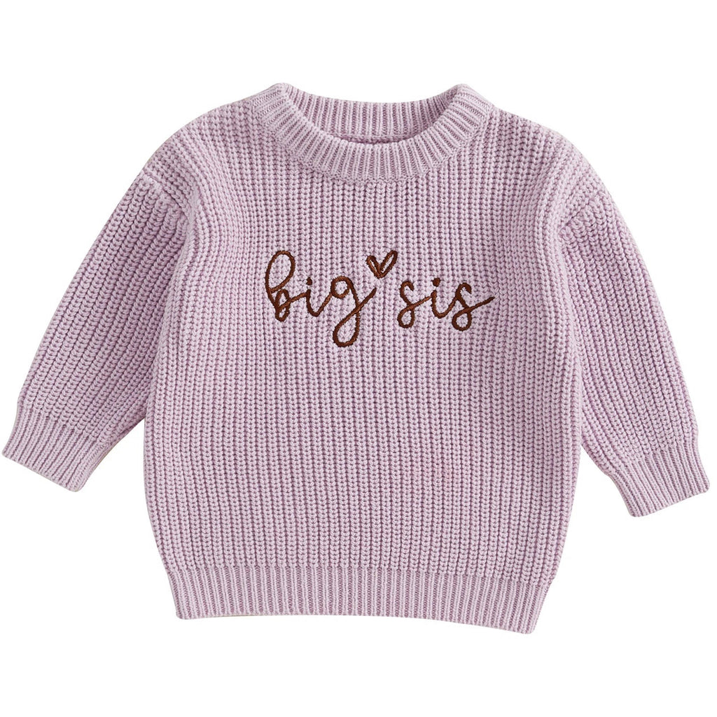 Flat lay of pink and purple chunky knit jumpers for toddlers – baby girl winter knitwear