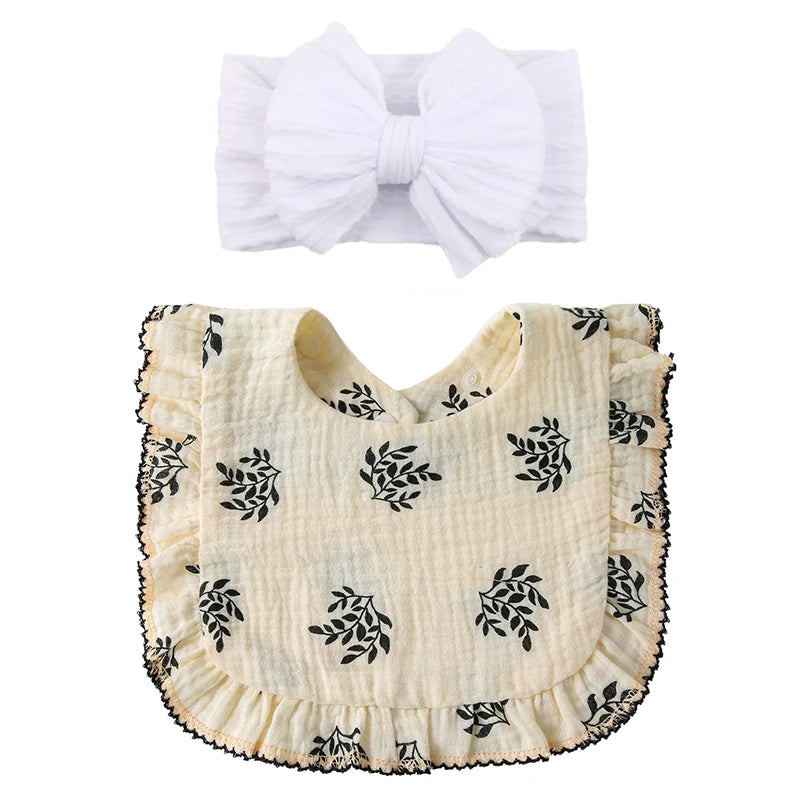 A baby bow topknot in white with a cream floral detail ruffle bib gift set 