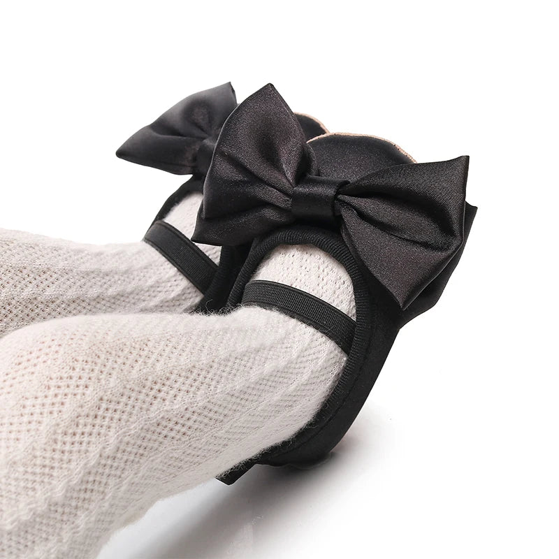 Black satin-look baby shoes with elastic strap